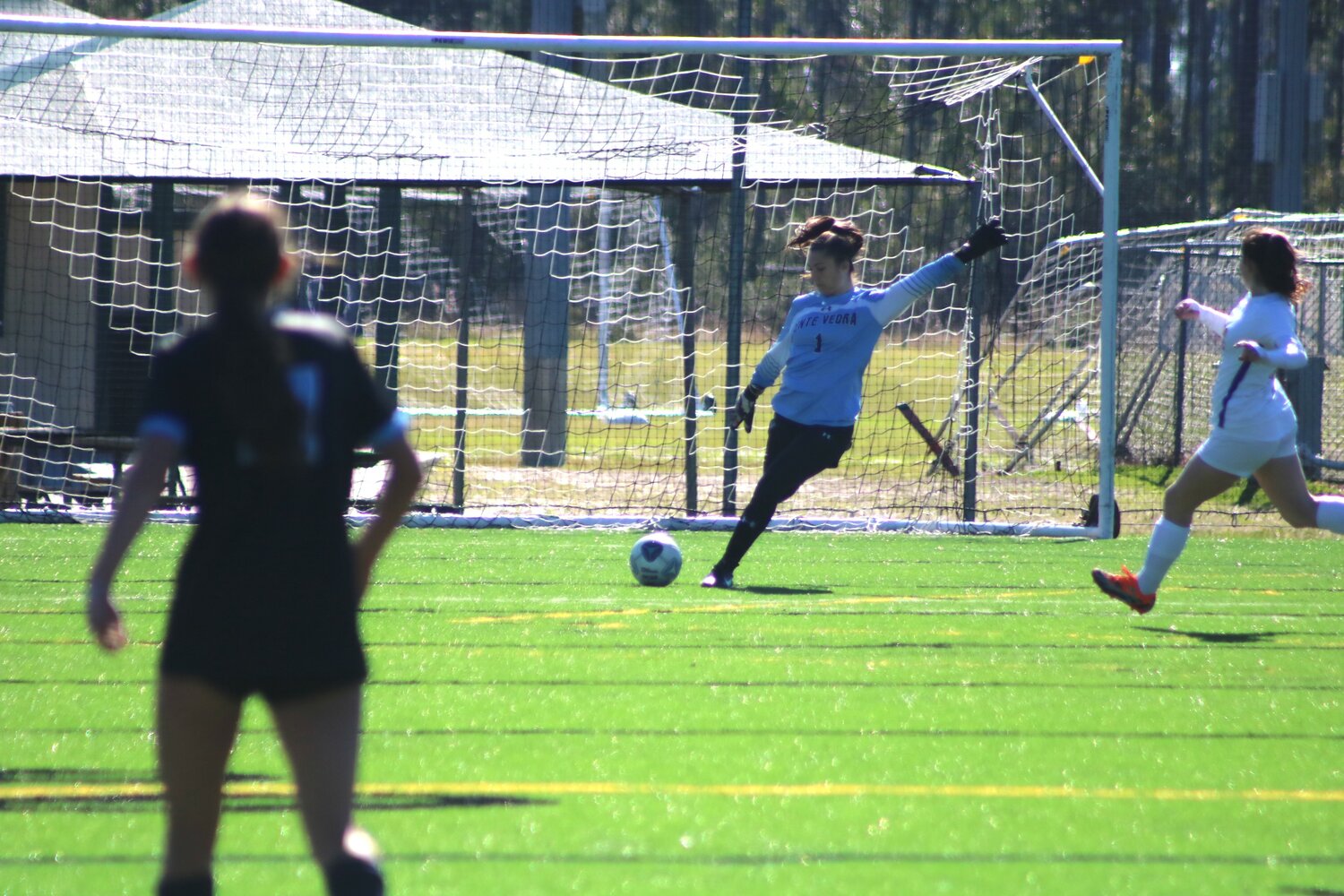 Goalkeeper Audrey Johnson winds up to kick the ball downfield.